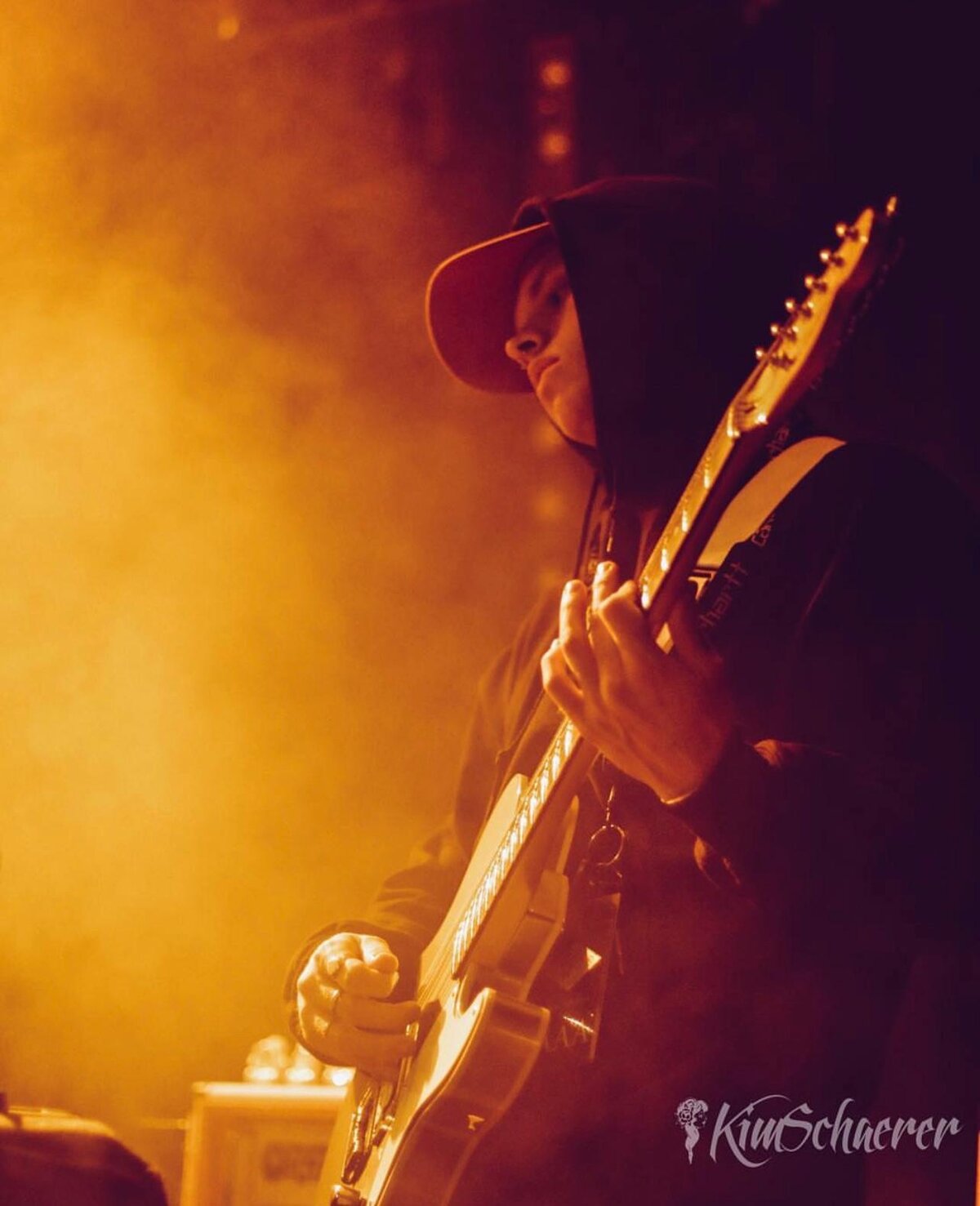 Beux Levi playing guitar live on stage