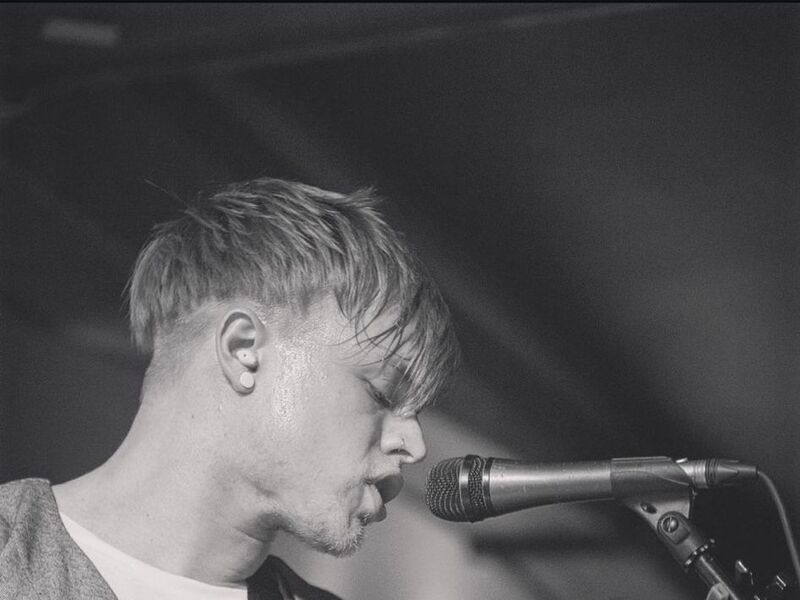 Beux Levi singing into a microphone